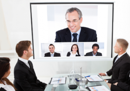 A large video meeting display in a conference room